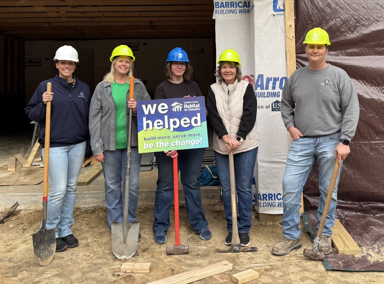 Group photo in front of construction site